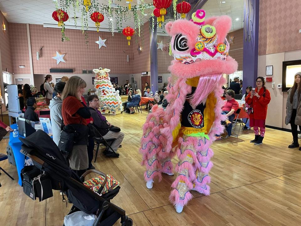 Lion dancers move through the crowd at The 418 Project